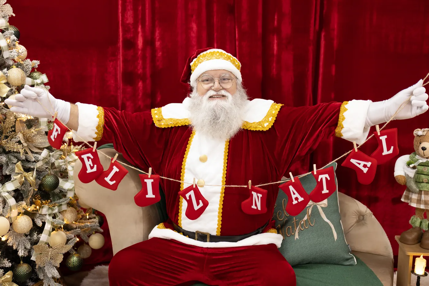 Papai Noel com varal de letras escrito Feliz Natal