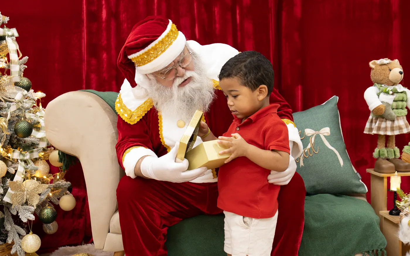 Menino recebendo um presente do Papai Noel no cenário de Natal